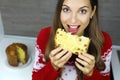Close up from above of young woman eating a slice of Panettone traditional Italian cake for Christmas with raisins and candied Royalty Free Stock Photo