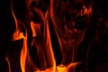 Close up. Abstrack background. Orange flame in the fireplace. Fire in the darkness. Copy space Royalty Free Stock Photo