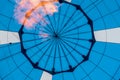 Close-up of abstract beautiful texture of geometric surface of hot air balloon, blue colors and flame from burner Royalty Free Stock Photo