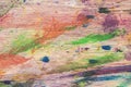 Close-up of abstract dirty painted wooden surface, paint of different bright colors