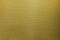 Close-up of abstract flat gold high detail textured clothing fabric pattern background partial focus and realistic light