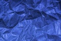 A close up abstract macro photo of crumpled creased paper lit with a blue flash gel Royalty Free Stock Photo