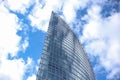 Close up abstract modern skyscraper architecture tall glass building with clouds in background Royalty Free Stock Photo