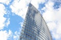 Close up abstract modern skyscraper architecture tall glass building with clouds in background Royalty Free Stock Photo