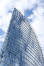 Close up abstract modern skyscraper architecture tall glass building with clouds in background Royalty Free Stock Photo