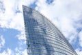 Close up abstract modern skyscraper architecture tall glass building with clouds in background Royalty Free Stock Photo