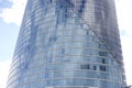 Close up abstract modern skyscraper architecture tall glass building with clouds in background Royalty Free Stock Photo