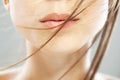 Close up abstract portrait of a beautiful caucasian girl with red lipstick. Windy hair blowing on face Royalty Free Stock Photo
