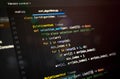 Close-up of abstract programming code with colorful syntax on a dark background, visualizing a selection sort algorithm structure Royalty Free Stock Photo