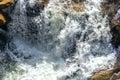 Close-up abstract texture above view of river torrent and clear fresh cold water flowing through mountain rocks in Royalty Free Stock Photo