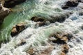 Close-up abstract texture above view of river torrent and clear fresh cold water flowing through mountain rocks in Royalty Free Stock Photo