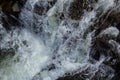 Close-up abstract texture above view of river torrent and clear fresh cold water flowing through mountain rocks in valley with Royalty Free Stock Photo