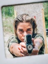 Close-up abstract view of attractive female army soldier with gun Royalty Free Stock Photo