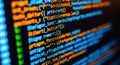 Close-up abstract view of computer code glowing with vibrant colors on a digital screen Royalty Free Stock Photo