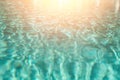 Close up abstract water texture. Turquoise swimming pool water background. Copy space, top view. Sun light effect and Royalty Free Stock Photo