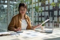 Close up accountant woman using calculator and laptop for do math finance on wooden desk in office and business working Royalty Free Stock Photo