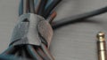 Close up of an acoustic cable lying on wooden table surface. Action. Rolled audio jack cable, details of professional Royalty Free Stock Photo