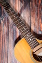 Close up of acoustic guitar. Acoustic guitar against an old wooden background Royalty Free Stock Photo
