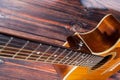 Close up of acoustic guitar. Acoustic guitar against an old wooden background Royalty Free Stock Photo