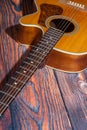 Close up of acoustic guitar. Acoustic guitar against an old wooden background Royalty Free Stock Photo