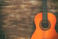 Close up of acoustic guitar against a wooden background Royalty Free Stock Photo