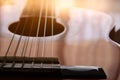 Close up of acoustic guitar against a wooden background Royalty Free Stock Photo