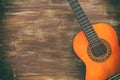 Close up of acoustic guitar against a wooden background Royalty Free Stock Photo