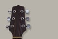 An acoustic guitar headstock on grey background. Royalty Free Stock Photo