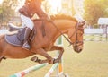 Equestrian rider horse jumping over hurdle obstacle during dressage test competition