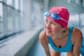 Close-up of active senior woman preapring for swim in indoors swimming pool. Royalty Free Stock Photo