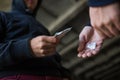 Close up of addict buying dose from drug dealer Royalty Free Stock Photo