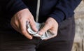 Close up of addict or drug dealer hands with money Royalty Free Stock Photo