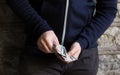 Close up of addict or drug dealer hands with money Royalty Free Stock Photo