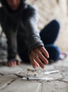 Close up of addict woman reaching to drug syringes Royalty Free Stock Photo