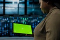 Close up of admin holding green screen tablet walking through server room Royalty Free Stock Photo