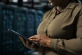 Close up of admin using tablet to do maintenance on data center electronics Royalty Free Stock Photo