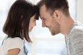 Close up adorable little daughter and father touching foreheads. Royalty Free Stock Photo