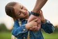 Close up of adorable little girl holding father& x27;s hand, looking at his wrist watch while playing with her daddy in the Royalty Free Stock Photo