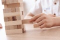 Close up. Adult father with small son plays Jenga at home. Royalty Free Stock Photo