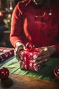 Close-up adult person hands wrapping a Christmas gift