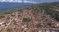Close-up aerial view of historic town Barichara, Colombia situated on a cliff edge, in the center green plaza and cathedral Royalty Free Stock Photo