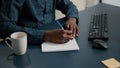 African american black person writing notes on notepad using a pen Royalty Free Stock Photo