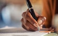 Close up of black woman hand writing on business document Royalty Free Stock Photo