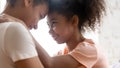 Close up african american daughter touching forehead with mother. Royalty Free Stock Photo