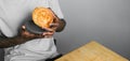 Close up african american hand holding soft layered pastry bun - copy space and empty space for text banner