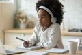 Close up African American little girl wearing headphones watching webinar Royalty Free Stock Photo