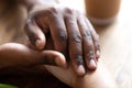 Close up african american male holding young beloved female hands. Royalty Free Stock Photo