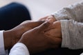 Close up African American man comforting woman, holding hands