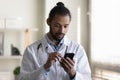 Close up African American man doctor using smartphone in hospital Royalty Free Stock Photo