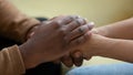 Close up african american man hands holding upset depressed woman.